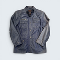 Blue jacket with zippers and buttons on a light gray background