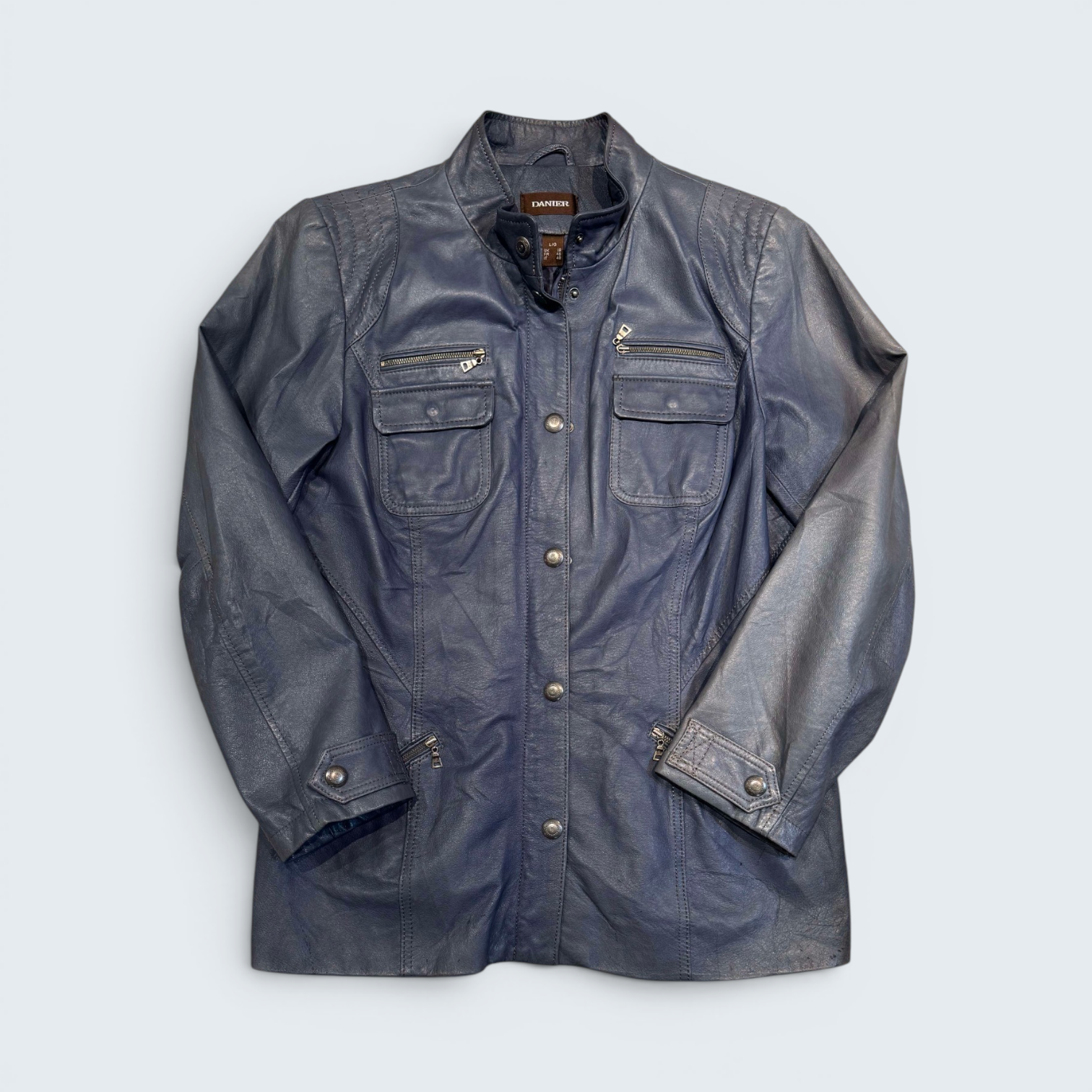 Blue jacket with zippers and buttons on a light gray background