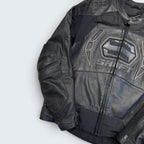 Black leather jacket with a brand logo on a light gray background