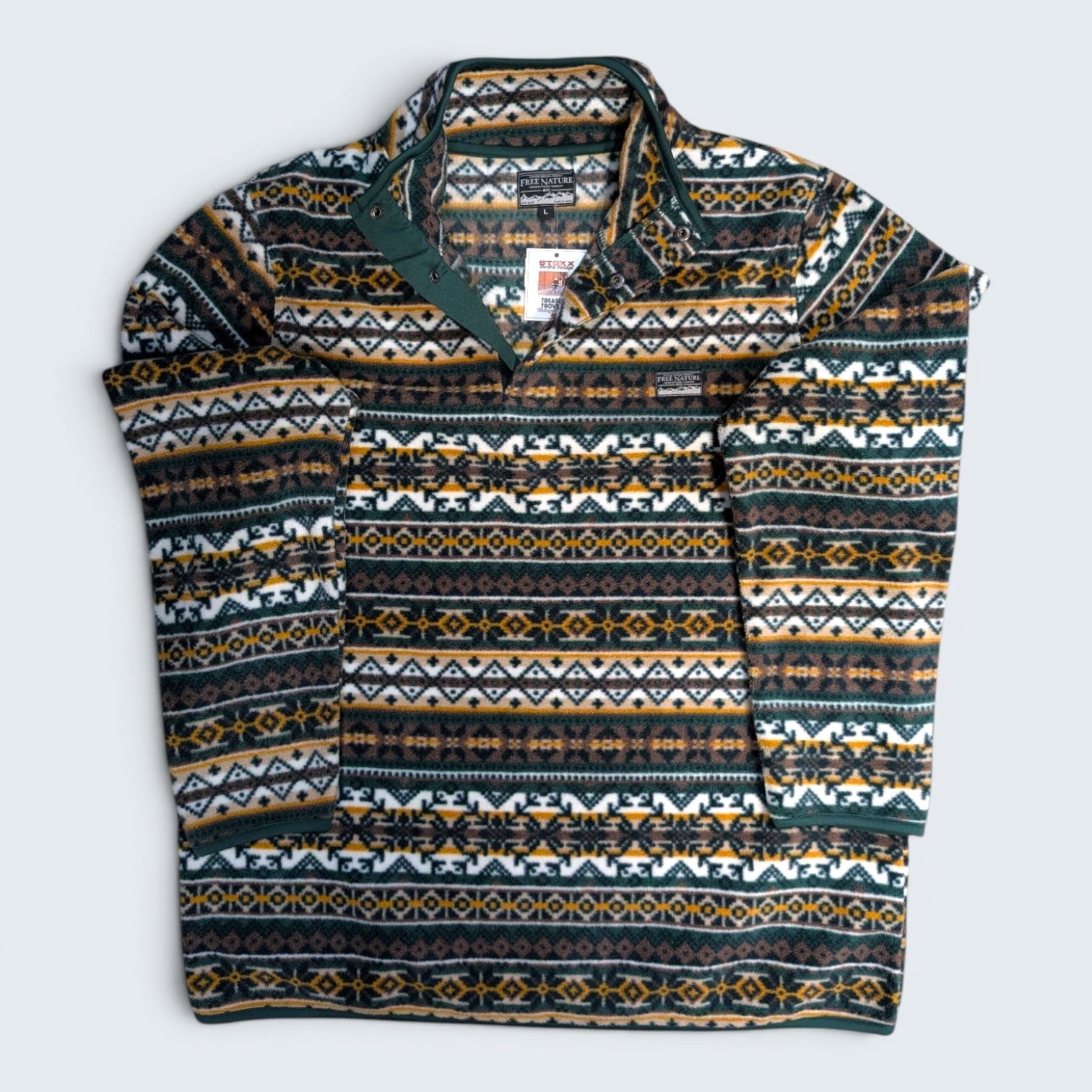 Patterned sweater with a brand tag on a light gray background