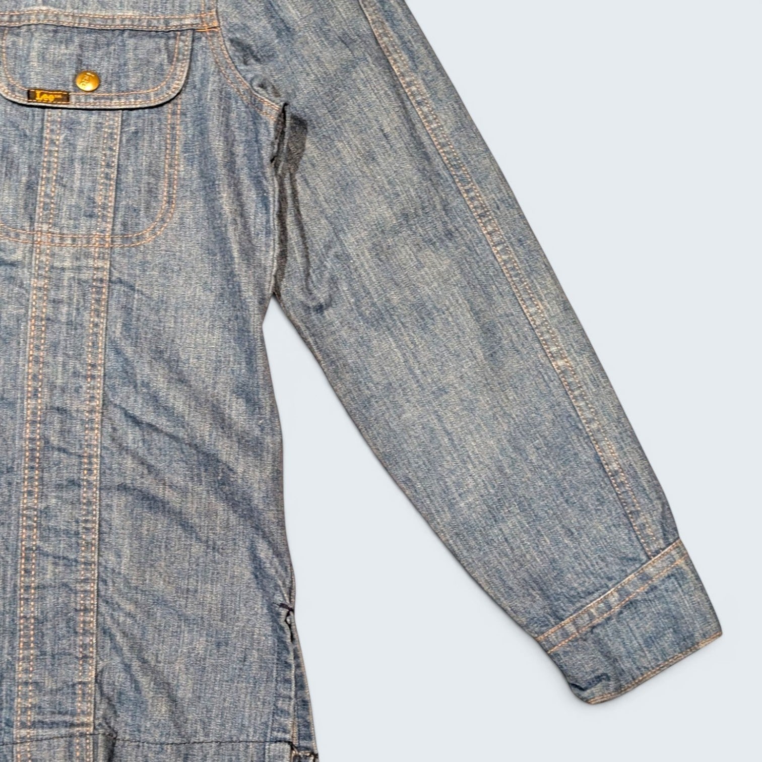 STOXX THRIFT & VINTAGE 1970s Lee long denim jacket in blue with gold buttons and contrast stitching, made in USA.