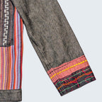 STOXX THRIFT & VINTAGE Attitude denim jacket featuring colorful striped fabric panels and decorative embroidery.