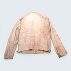 Back view of a beige suede biker jacket from STOXX THRIFT & VINTAGE featuring zippered cuffs and panel detailing.