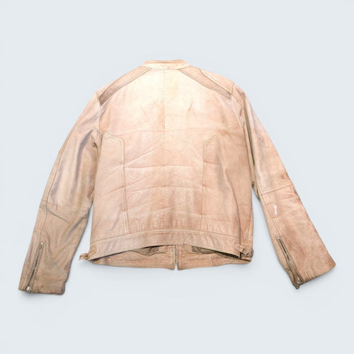 Back view of a beige suede biker jacket from STOXX THRIFT & VINTAGE featuring zippered cuffs and panel detailing.