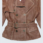 STOXX THRIFT & VINTAGE XNTRIK brown leather blazer with double-breasted button closure and adjustable waist belt.