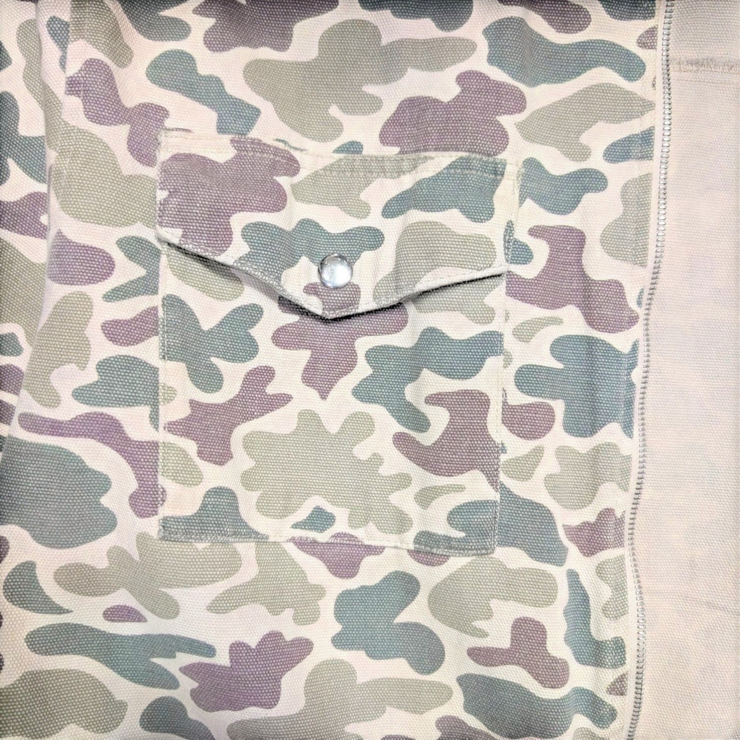 STOXX THRIFT & VINTAGE camo print chore jacket in heavy canvas with a button-flap chest pocket and zip closure.