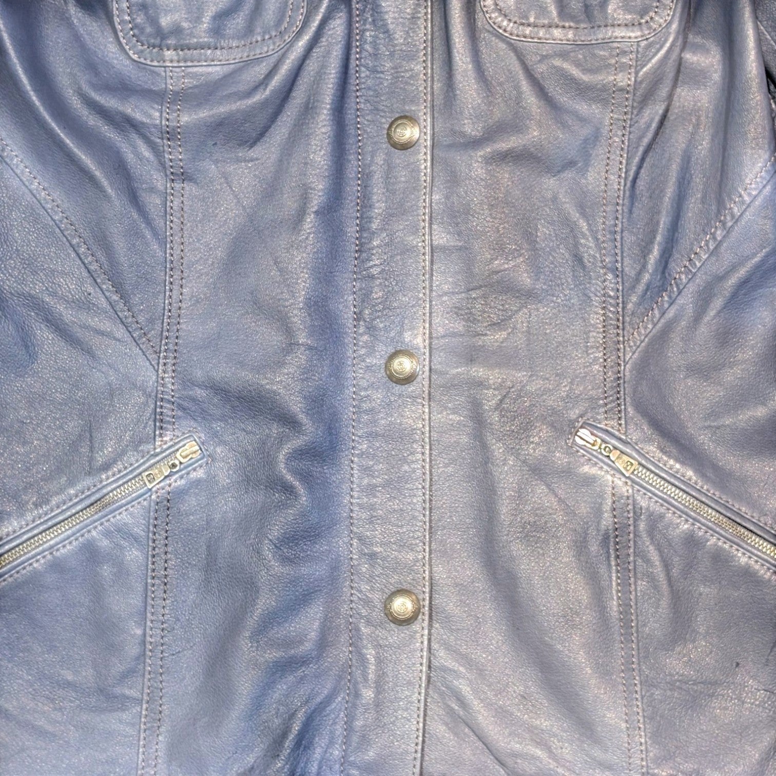 STOXX THRIFT & VINTAGE Danier blue leather long jacket with silver button closure and zippered pockets.