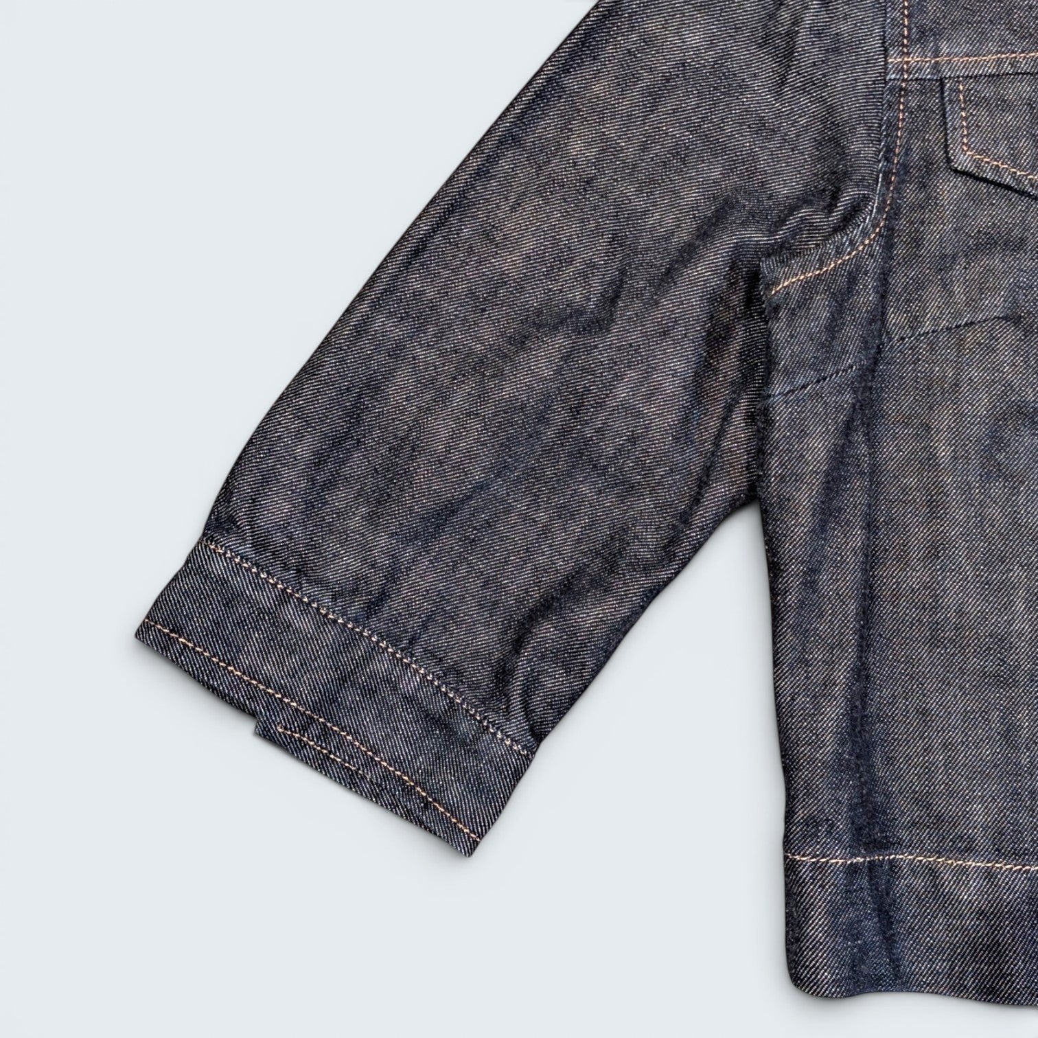STOXX THRIFT & VINTAGE dark wash Dolce & Gabbana denim jacket sleeve with contrast stitching detail.