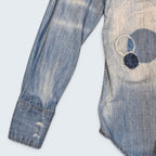 STOXX THRIFT & VINTAGE DSQUARED2 light wash denim shirt with circular patchwork and distressed details.