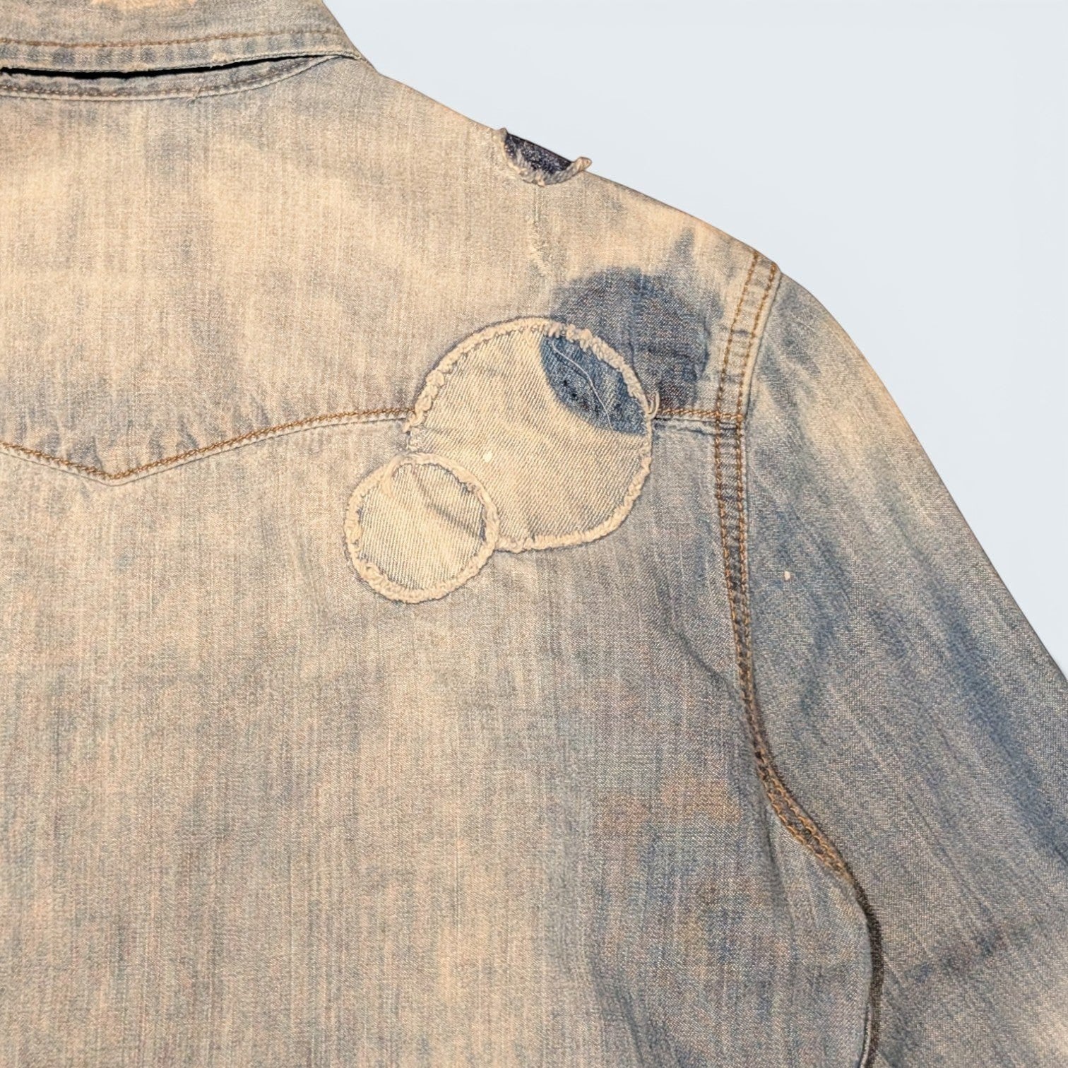 STOXX THRIFT & VINTAGE light wash DSQUARED2 denim shirt featuring circular patchwork and distressed details.