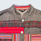 STOXX THRIFT & VINTAGE Attitude denim jacket featuring colorful embroidered patterns, striped trim, and metal buttons.