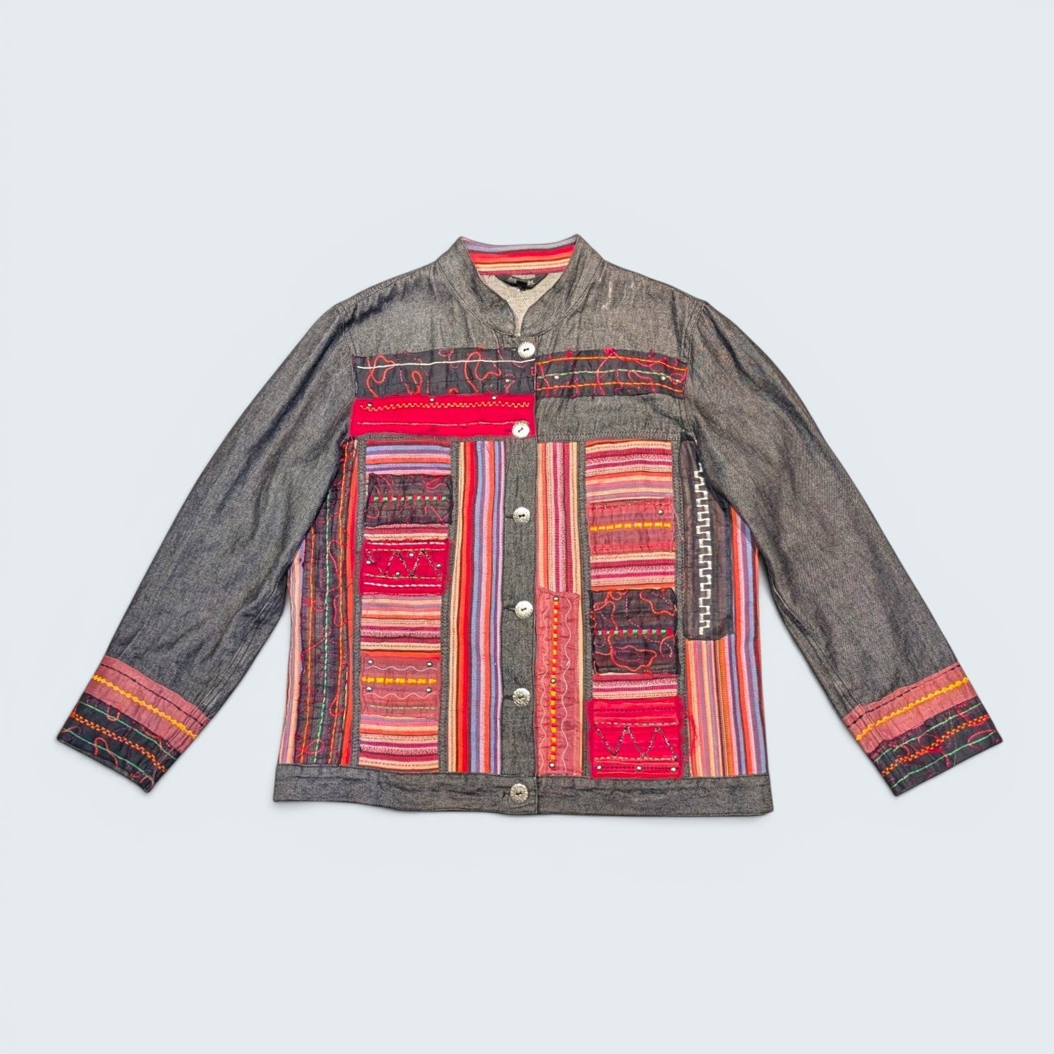 STOXX THRIFT & VINTAGE Attitude denim jacket featuring colorful patchwork embroidery, button front, and mandarin collar.