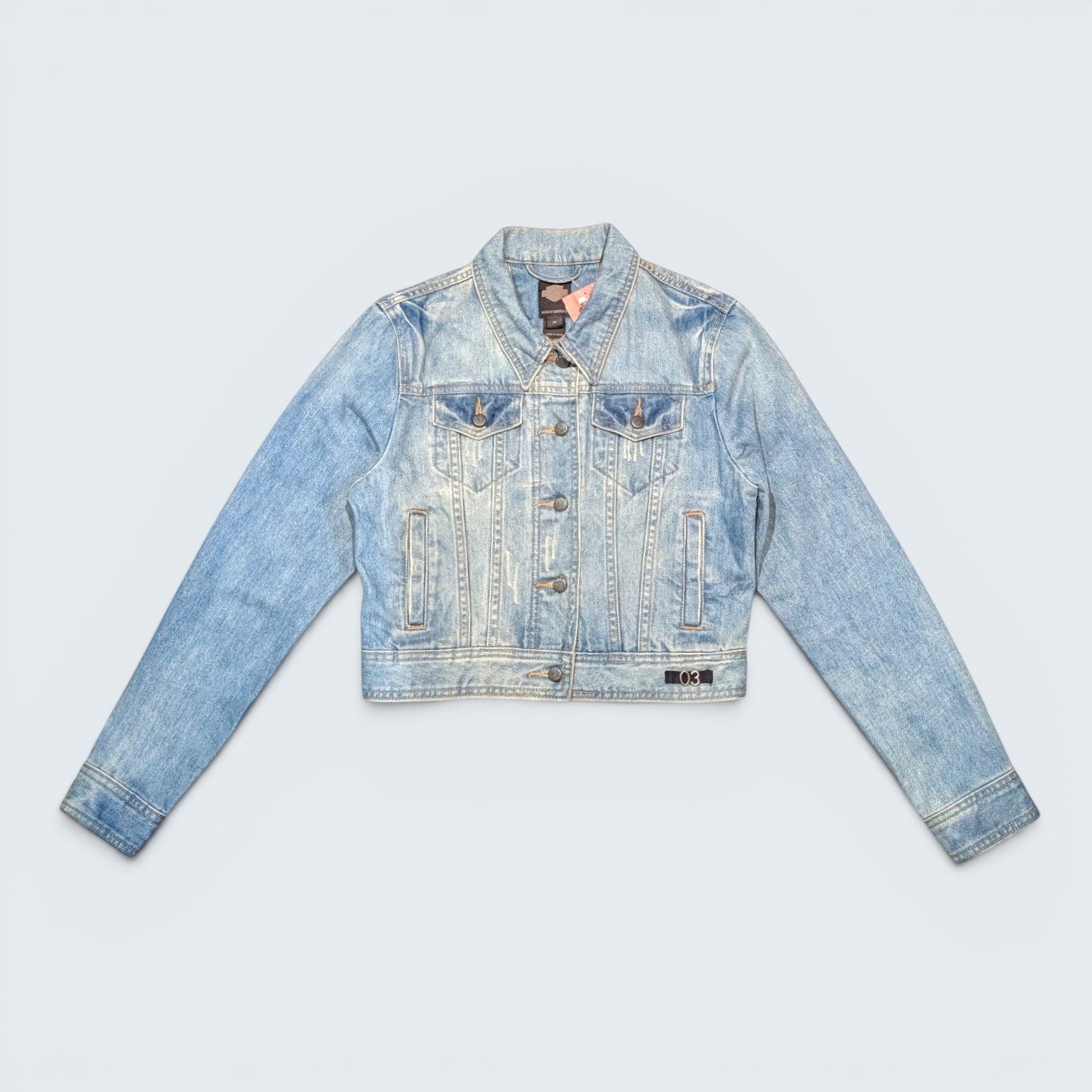 STOXX THRIFT & VINTAGE Harley Davidson light wash denim jacket with 03 patch, button-up front, and chest pockets.