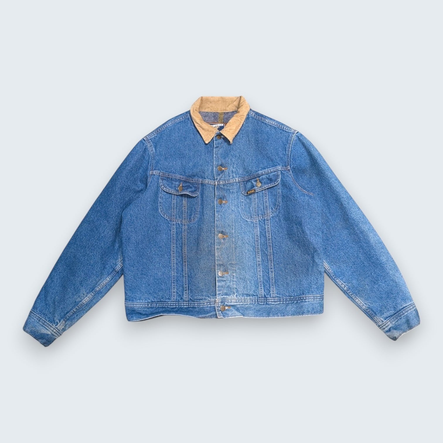 STOXX THRIFT & VINTAGE Levi's Stormrider medium-wash denim jacket with a tan corduroy collar and button-up front.