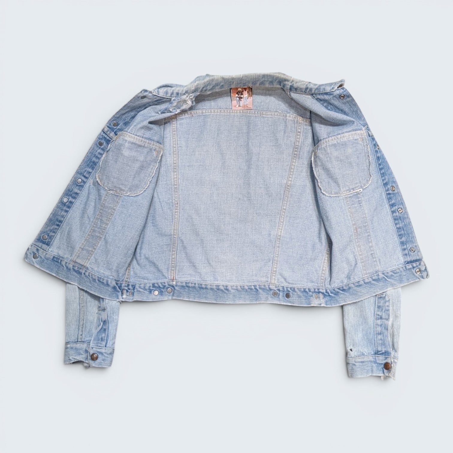 STOXX THRIFT & VINTAGE light wash GWG denim jacket with button-front closure and interior chest pockets.