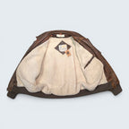 STOXX THRIFT & VINTAGE London Fog brown distressed leather bomber jacket with cream sherpa lining and ribbed hem.