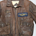 STOXX THRIFT & VINTAGE London Fog brown distressed leather bomber jacket with cream sherpa lining and fighter patch.