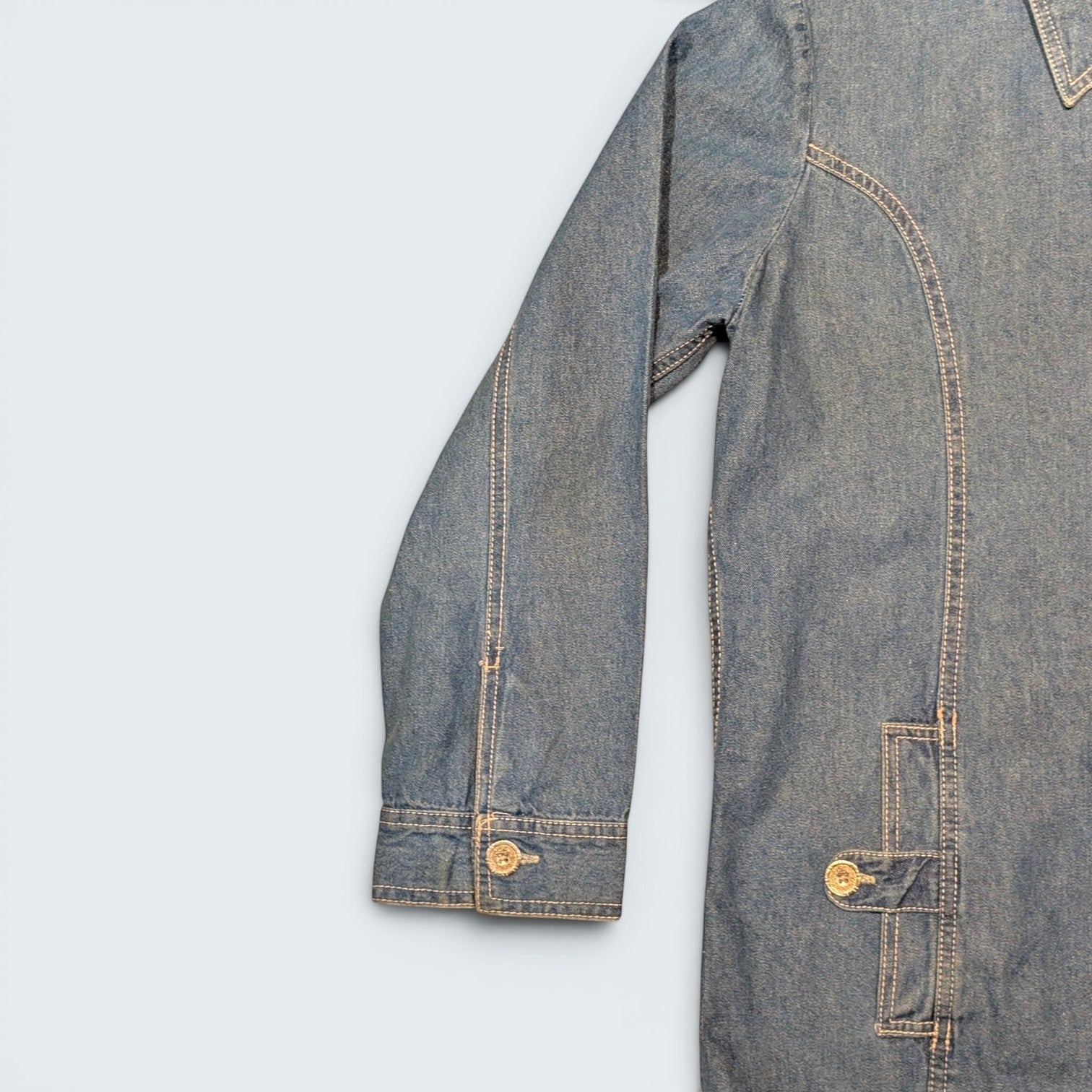 STOXX THRIFT & VINTAGE Tudor Court long denim jacket in blue with contrast stitching and buttoned cuffs.