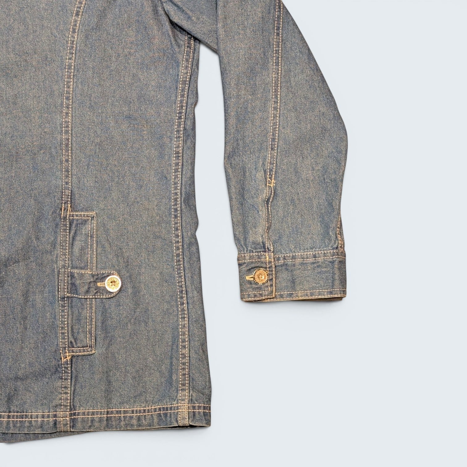 STOXX THRIFT & VINTAGE Tudor Court long blue denim jacket with contrast stitching and buttoned pocket detail.