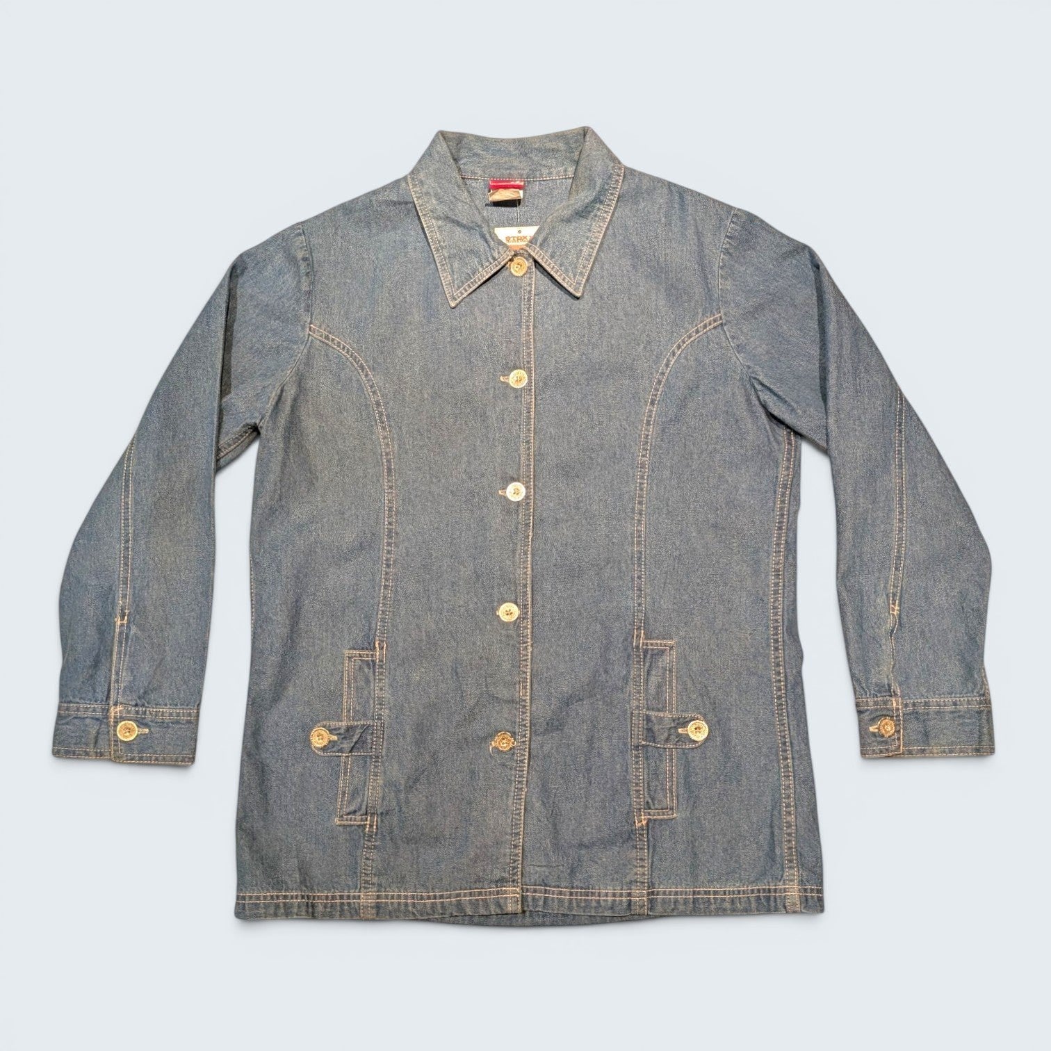 STOXX THRIFT & VINTAGE Tudor Court long blue denim jacket with button-front closure and front pockets.