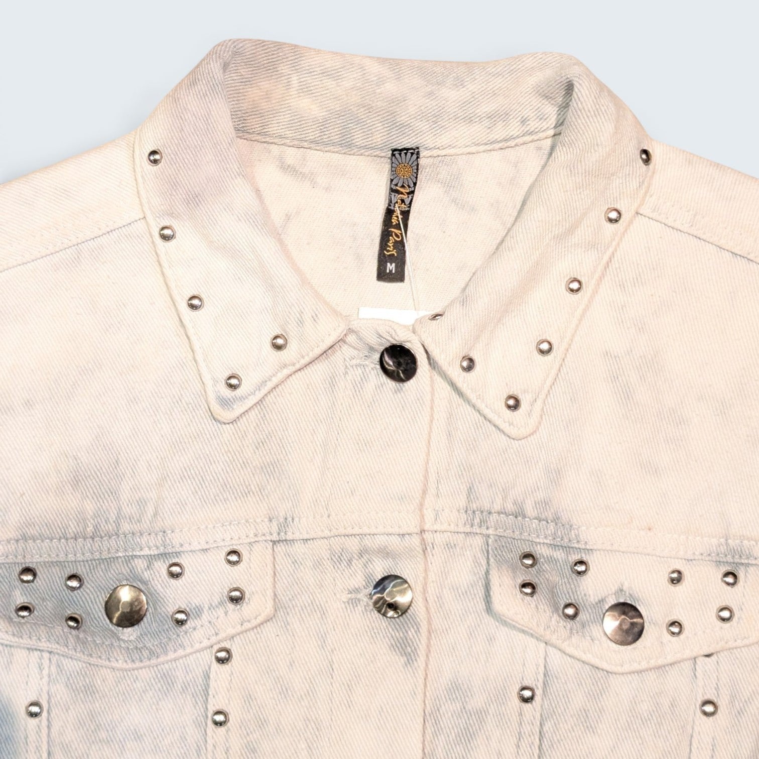 STOXX THRIFT & VINTAGE Natalia Paris light wash denim jacket with silver stud embellishments on collar and pockets.
