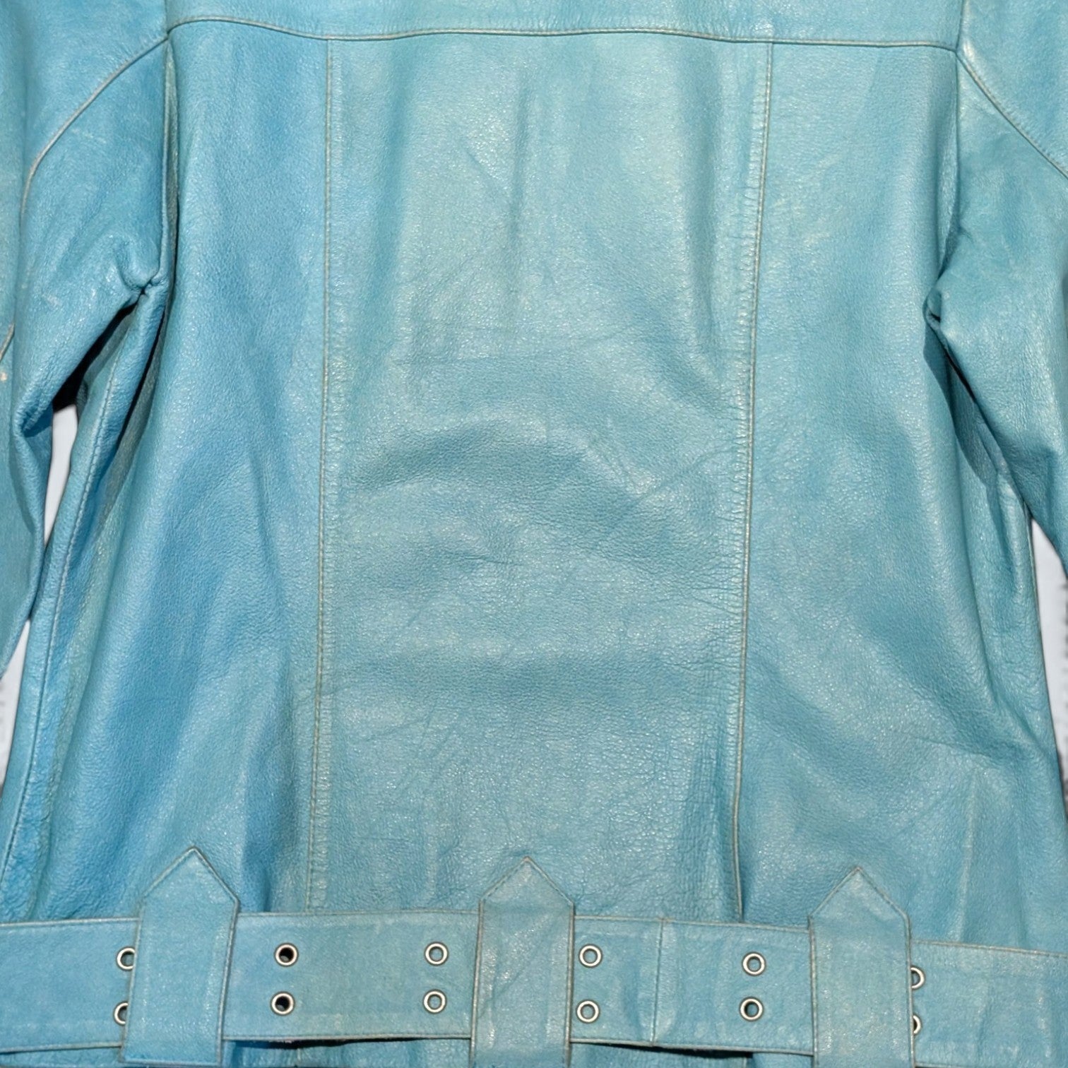 STOXX THRIFT & VINTAGE Vero Moda light blue leather jacket with a buckled waist belt and paneled back design.