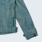 STOXX THRIFT & VINTAGE Vero Moda blue leather jacket with silver zipper details and adjustable waist buckle.