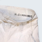 STOXX THRIFT & VINTAGE white cotton sailor trousers with H. Simmonds branding and button-fly closure.