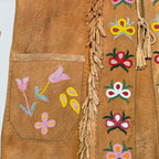 STOXX THRIFT & VINTAGE tan suede jacket with hand-sewn beaded floral patterns, fringe trim, and tassel tie closure.
