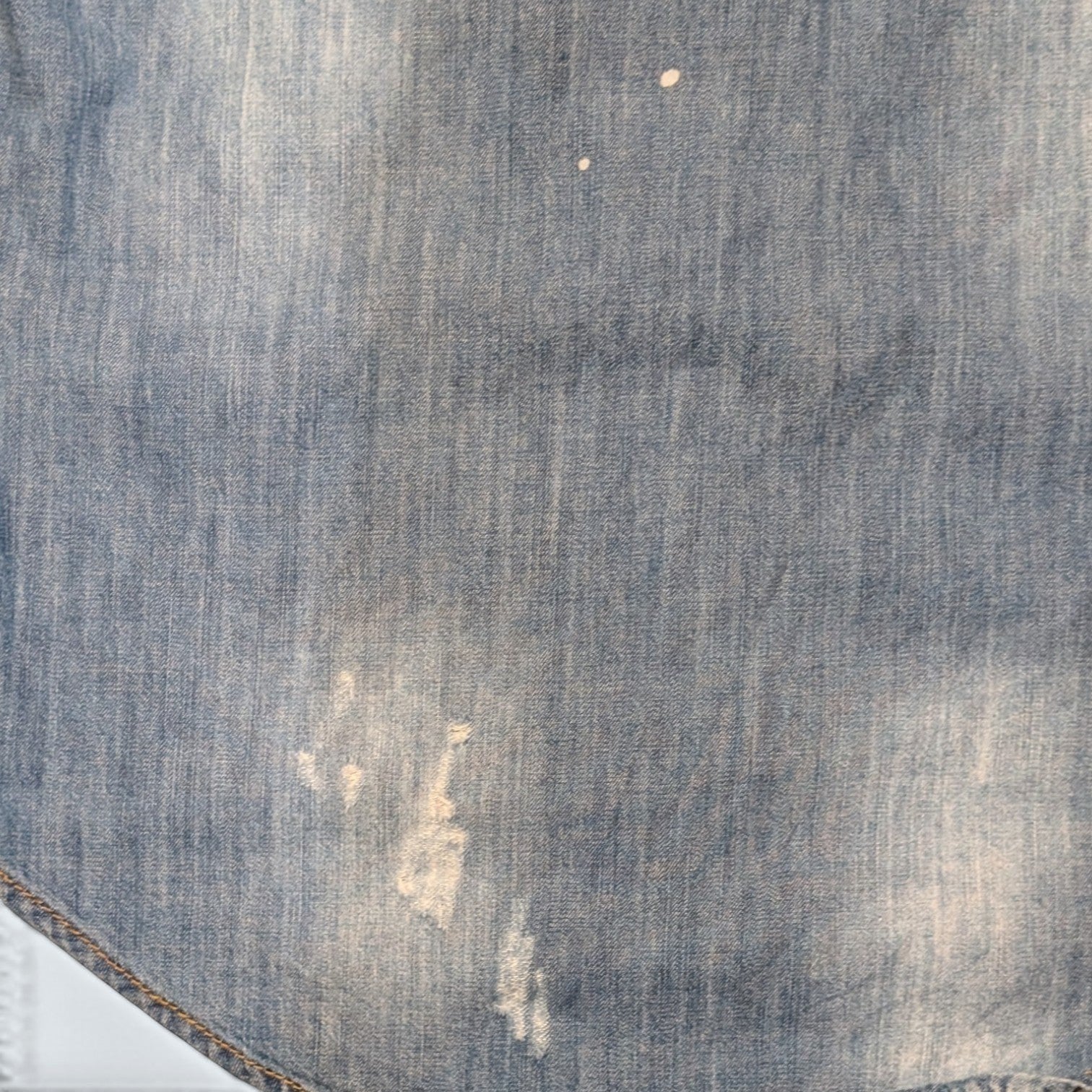 STOXX THRIFT & VINTAGE light wash denim shirt with distressed finish and paint splatter details.