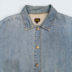 STOXX THRIFT & VINTAGE light blue Lee denim jacket with classic collar and branded silver snap-button closure.